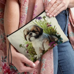 Cream canvas makeup bag with Shih Tzu illustration and floral patterns held by hand