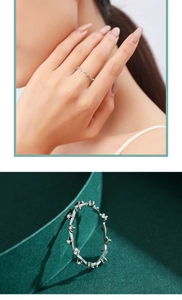 Detailed view of s925 silver wave ring featuring micro-pave crystals on green velvet