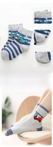 Detail view of cotton baby boy socks with tractor embroidery and striped pattern