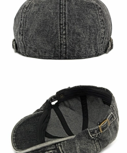 Detail van grijze gewassen denim krantenjongenspet met koperen gesp en stikseldetails