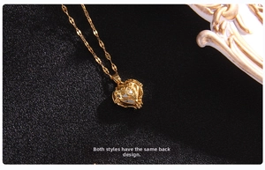 Detailed view of the gold heart pendant's back with intricate vintage filigree texture