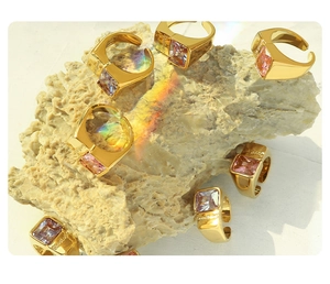 Detail of gold-plated signet rings with colorful square gems and GoodLuck engraving