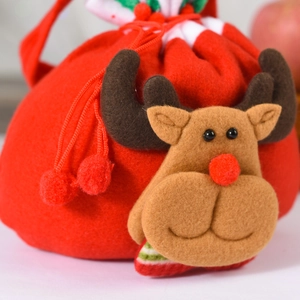 Close-up of 3D reindeer Christmas gift bag with plush texture and red drawstring