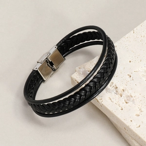 Detail of multi-strand black braided leather bracelet with silver stainless steel clasp