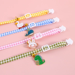 Detailed view of checkered pet collars with colorful animal charms and safety buckles
