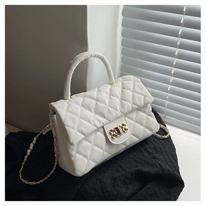 Close-up of white quilted PU leather handbag with elegant gold chain and metal clasp detail