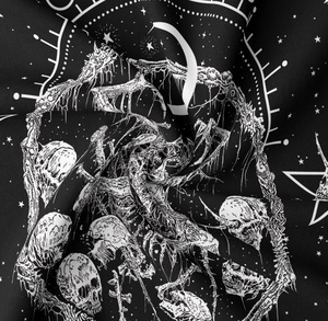 Detail of gothic black fabric featuring white moon, stars, and skull patterns for tapestry