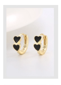 Macro detail of S925 hallmark on gold plated double heart earrings with black enamel