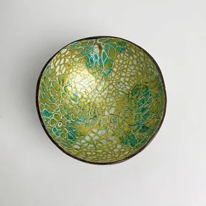 Macro view of green and gold mosaic inlay on a decorative Vietnamese coconut shell bowl
