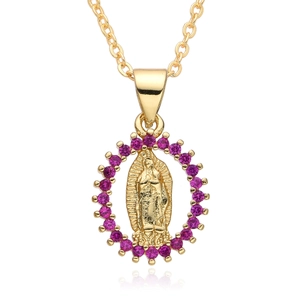 Close-up of golden Guadalupe pendant with red zircon stones on a fine link chain