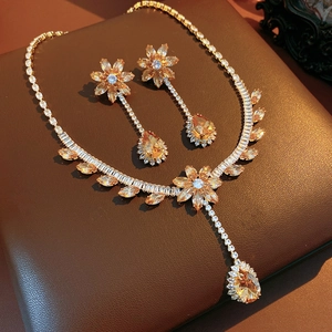 Detailed macro view of vintage flower jewelry set with yellow zircon and gold finish