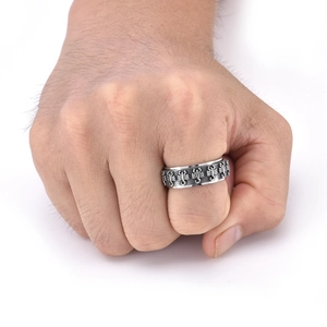 Detail of vintage embossed scorpion rotating fidget ring on a male model's hand