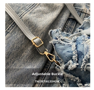 Detail of adjustable leather strap with gold buckle on quilted denim bucket bag