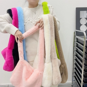 Variety of colorful faux fur shoulder bags in pink, green, and blue for winter style