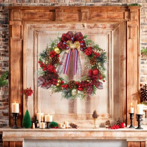 Detail view of a Christmas wreath with plaid bow, pine cones and berries on a wooden mantel