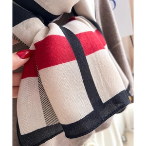 Plaid knitted scarf in red black and beige check pattern for autumn and winter warmth