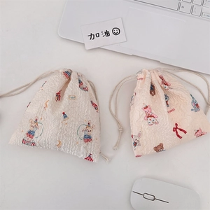 Detail of seersucker drawstring bags with circus bunny and cartoon animal patterns