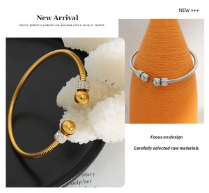 Macro detail of gold and silver snake chain bracelets with sparkling pavé crystal beads