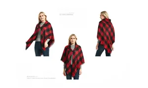 Macro detail of red and black plaid poncho featuring toggle closure and fringe hem