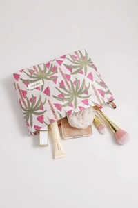 Close-up of tropical palm jacquard cosmetic bag with makeup brushes and mirror