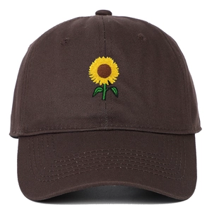 Detail shot of yellow sunflower embroidery on a brown twill cotton baseball cap