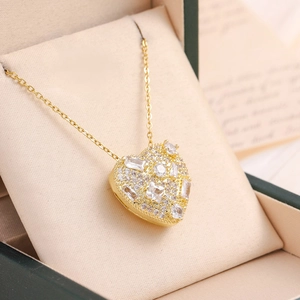 Macro view of gold heart pendant with zircon stones in a premium jewelry gift box