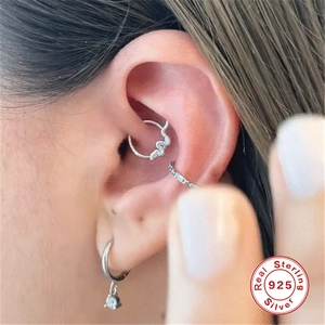 Macro view of S925 sterling silver ear piercing set featuring bat wing and diamond accents