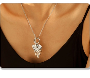 Close-up of molten heart pendant with pavé crystals on a silver stainless steel chain