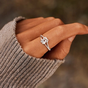 Minimalist s925 silver open ring with double heart knot design worn by a female model