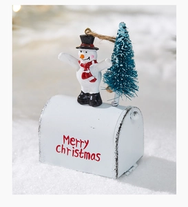 Detail of white metal Christmas mailbox with snowman, mini tree and Merry Christmas text