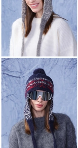 Detail of colorful striped knitted winter earflap hats with pom-pom and Nordic patterns