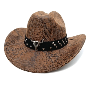 Detail of western cowboy hat with faux snake texture and silver bull skull metal ornament