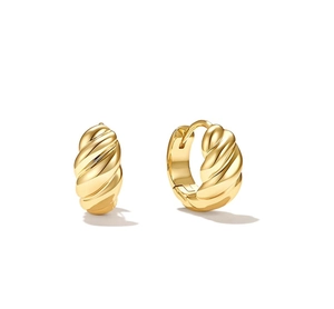 Macro view of gold-tone croissant hoop earrings featuring twisted metal textures