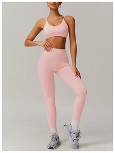 Detailed view of pink racerback sports bra and high-waist yoga leggings on model