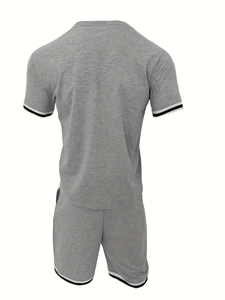 Detail of grey men's knit sports set showing striped ribbed cuffs and fabric texture