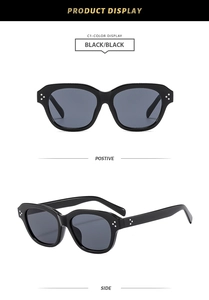 Detail view of square black sunglasses showing silver triple rivet hinges and sleek frame