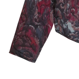 Detail of quilted suede biker jacket cuff showing abstract prints and precise stitching