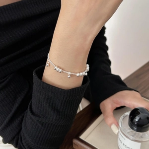 Detailed close-up of 925 sterling silver chain bracelet with beads on woman wrist