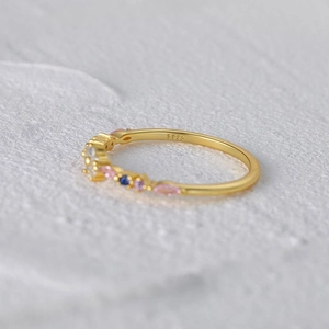 Close-up of S925 sterling silver stamp on golden ring with multicolored gemstones