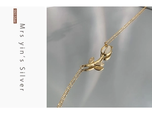 Detail of S925 silver tulip bracelet with white chalcedony and small diamonds in gold