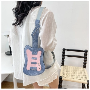 Detailed back view of a guitar-shaped crossbody bag with blue denim and pink panels