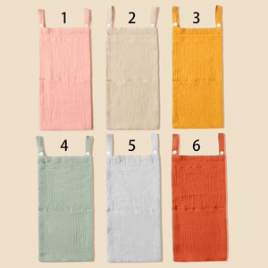 Detailed grid of six-color muslin cotton crib organizers with snap-button hanging straps