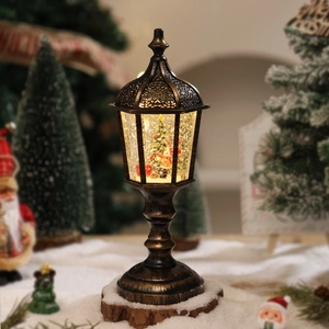 Close-up of vintage bronze Christmas snow globe lamp with swirling glitter and tree