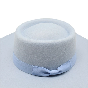 Detail of light blue wool felt fedora showing the elegant ribbon and bow decoration