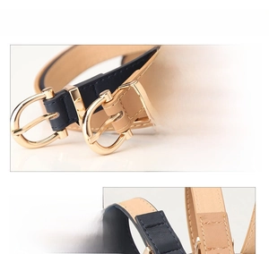 Detailed macro view of dark blue and beige PU leather belts with gold alloy buckles