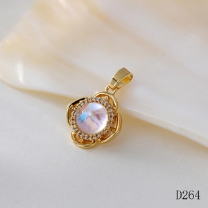Macro shot of gold floral pendant featuring a moonstone center and crystal accents