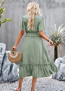 Detail view of grass green V-neck dress with ruffle sleeves and high elastic waist