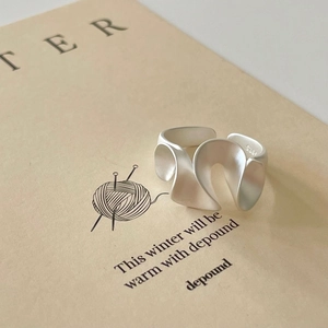 Minimalist S925 sterling silver ring with a twisted wave design and matte silver finish
