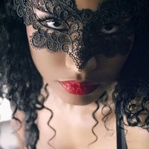 Close-up of elegant black lace masquerade mask with intricate hollow patterns for parties