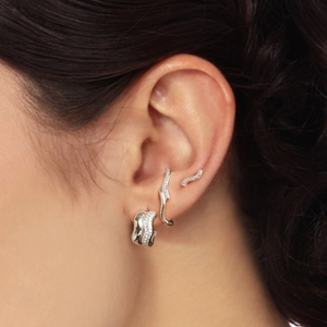 Macro shot of S925 sterling silver half-moon pearl C-shape earrings and ear cuff on ear